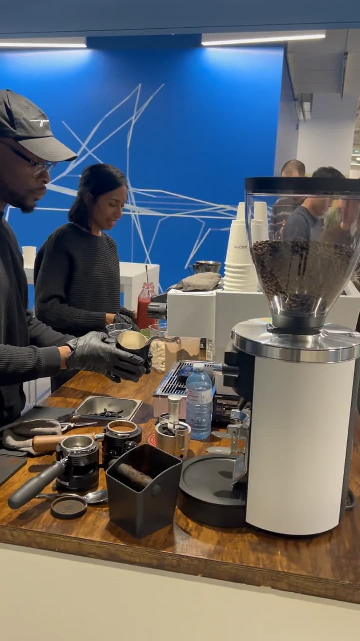 A barista preparing espresso at the RoastAroma event cart