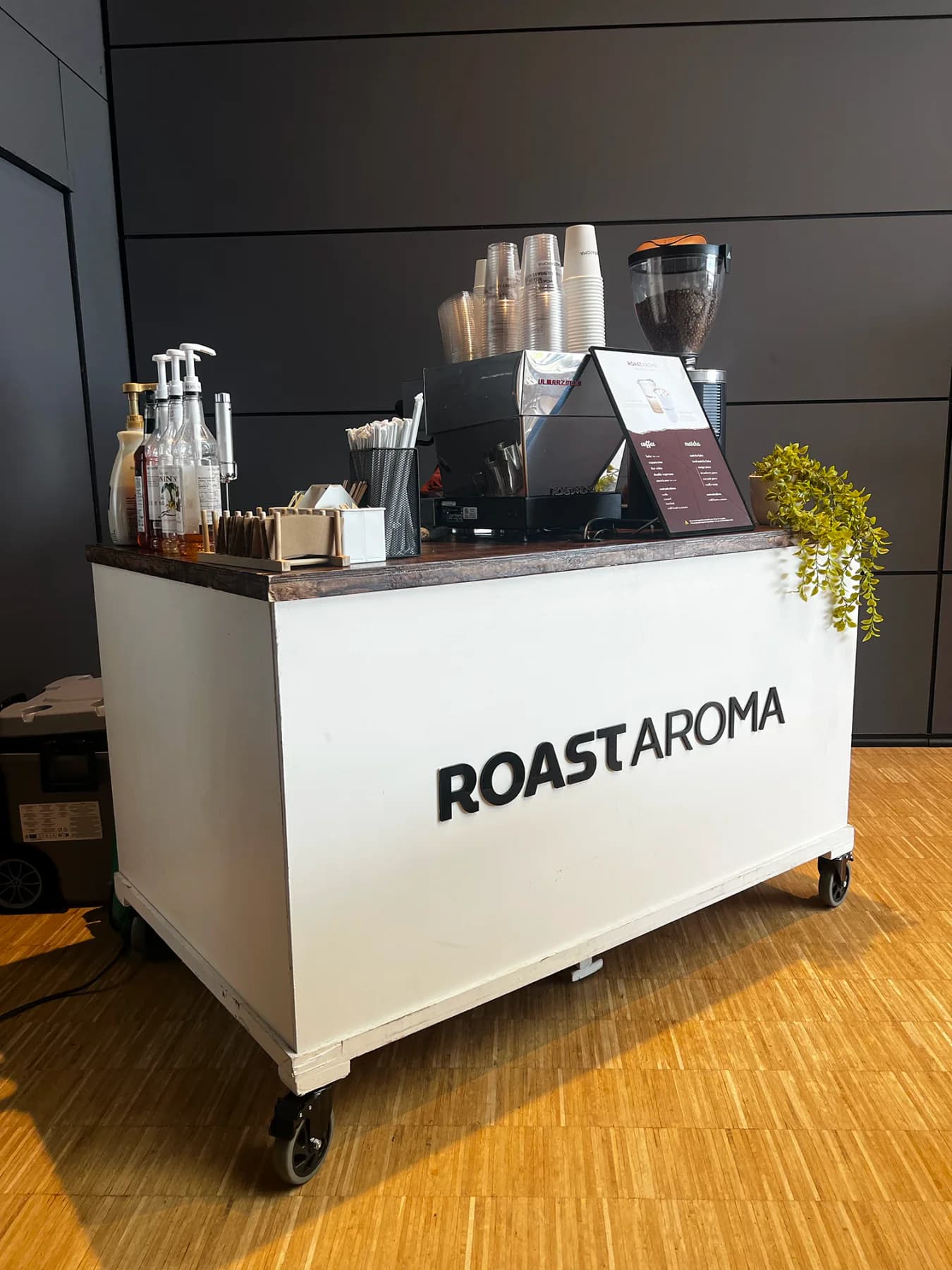 RoastAroma coffee cart positioned inside an event venue