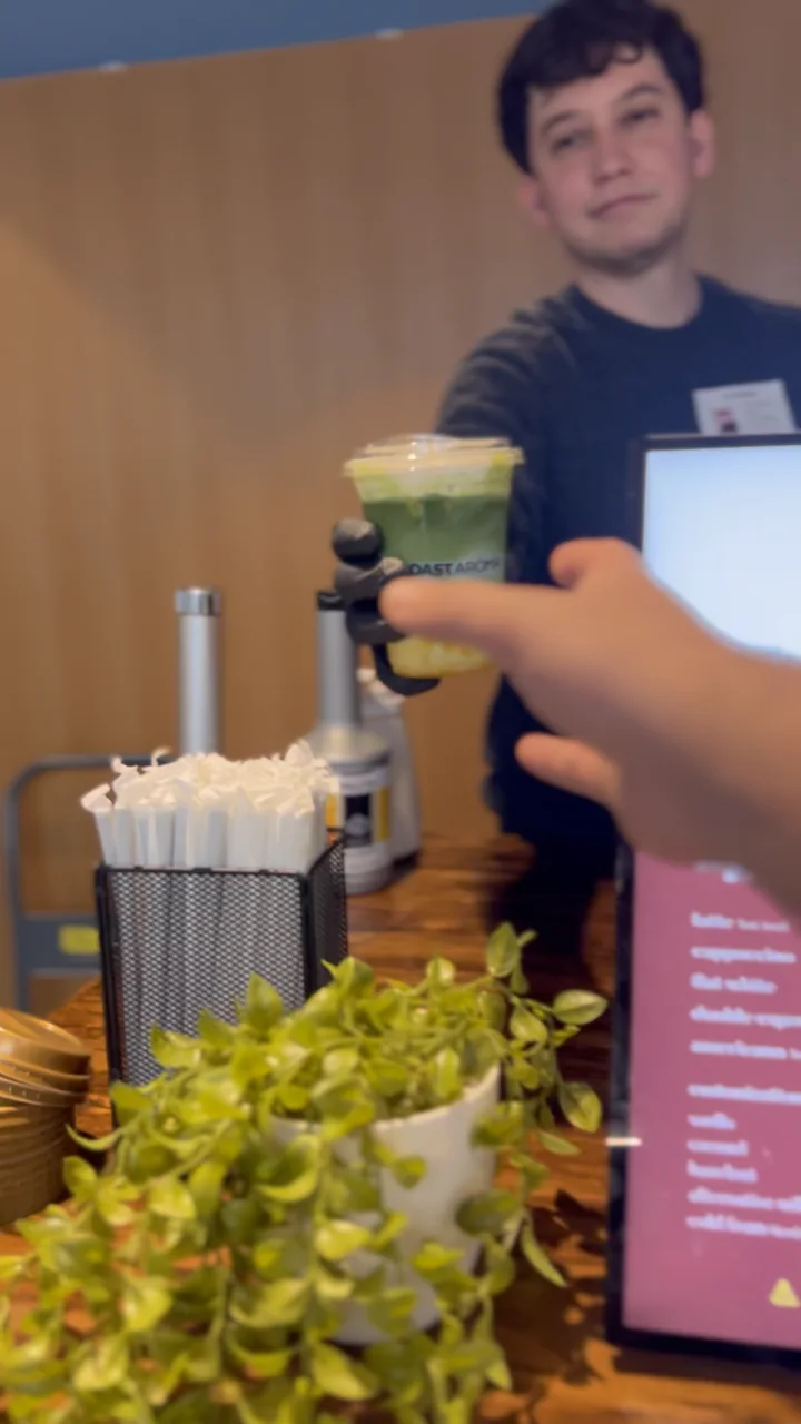 A drink being handed to a guest at a wedding café