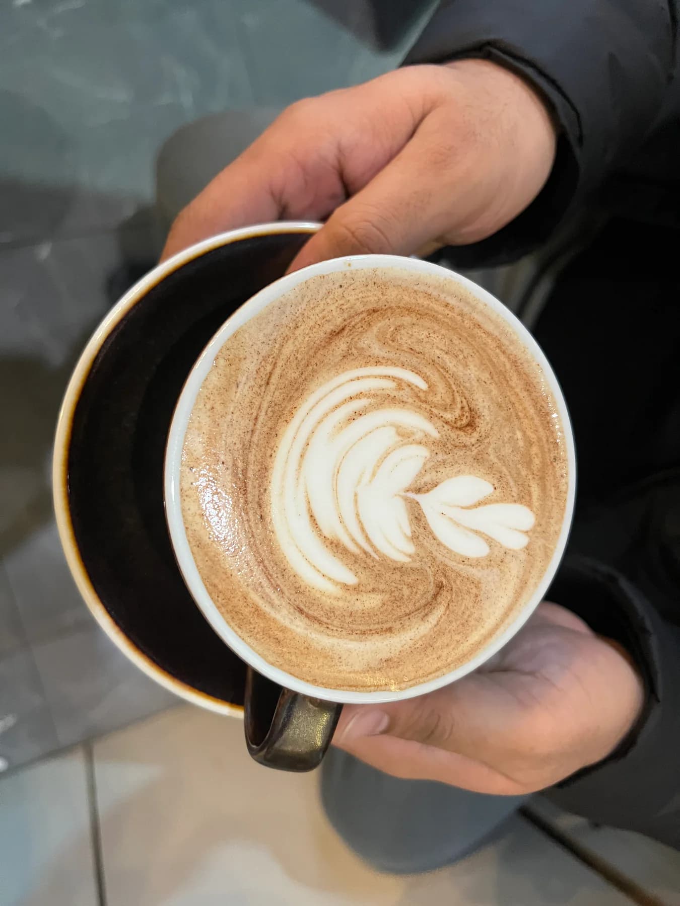 A guest holding a latte at a wedding