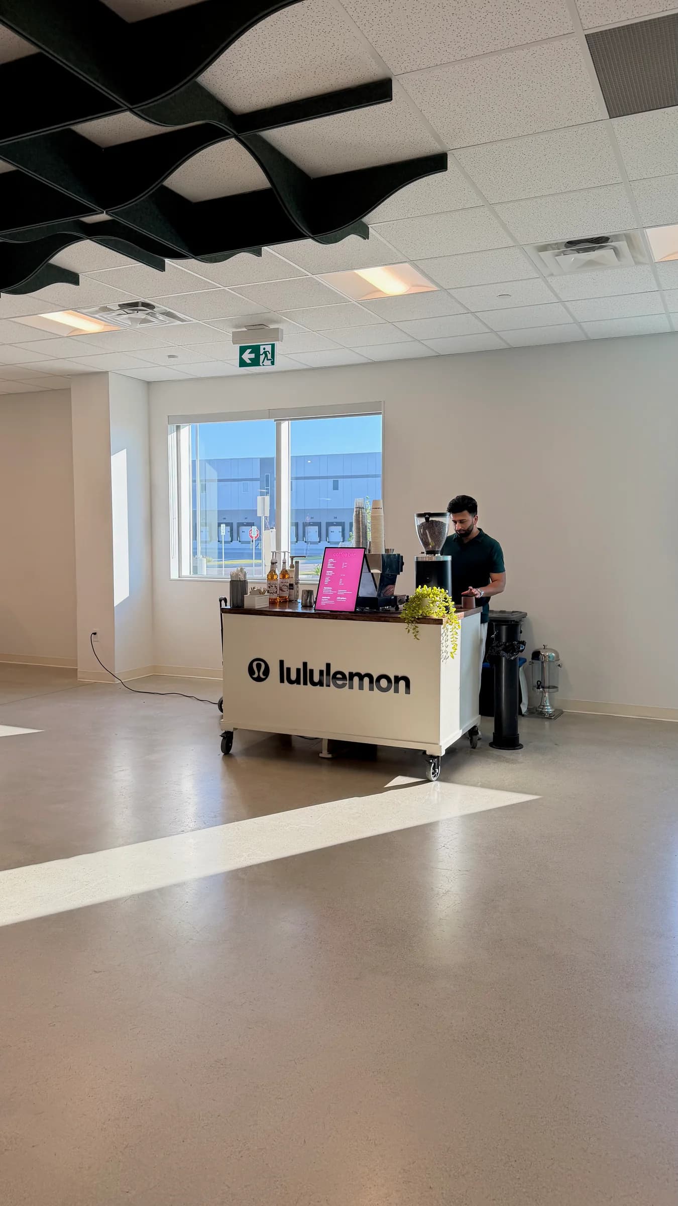 A branded RoastAroma coffee cart during live service