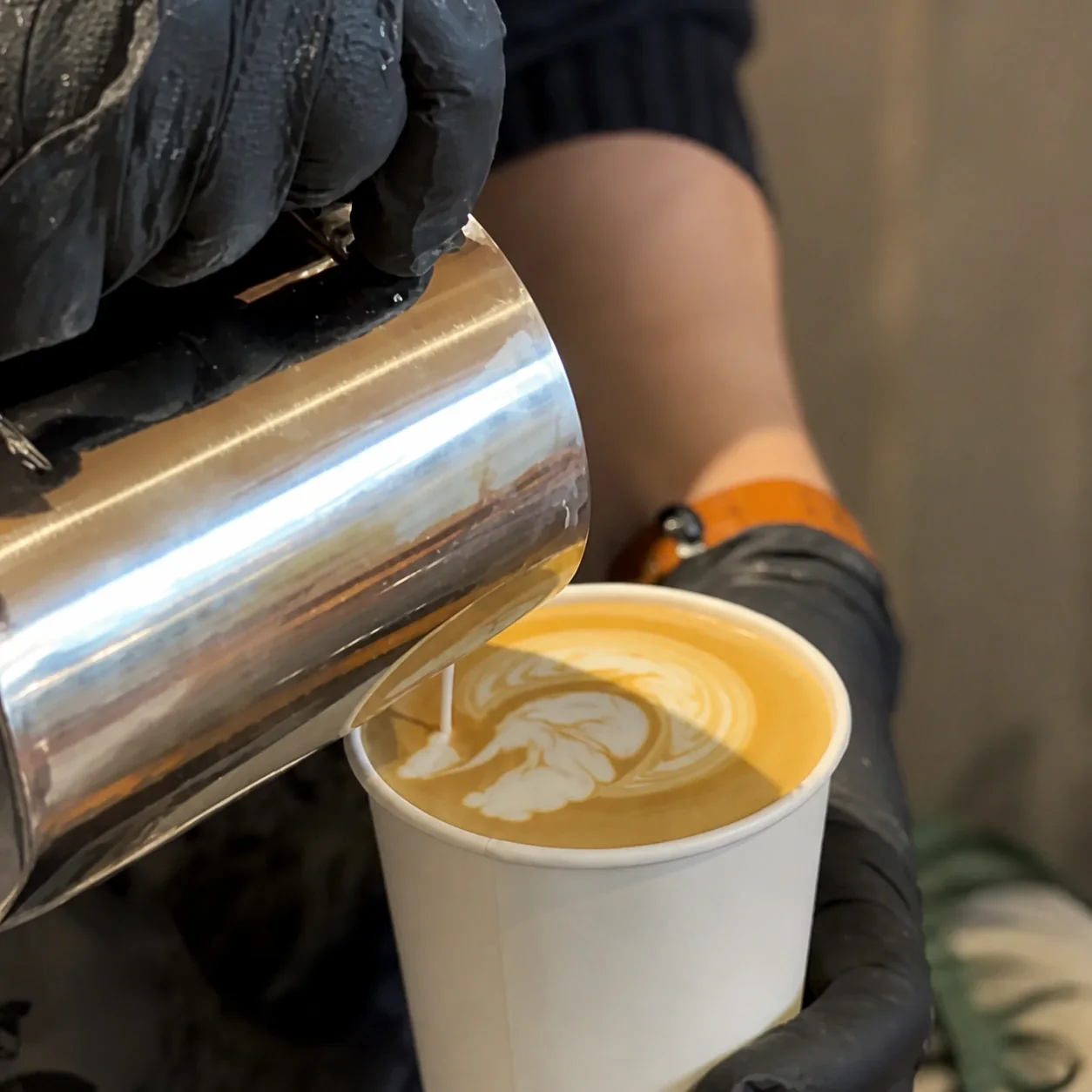 Milk being poured into espresso to create latte art