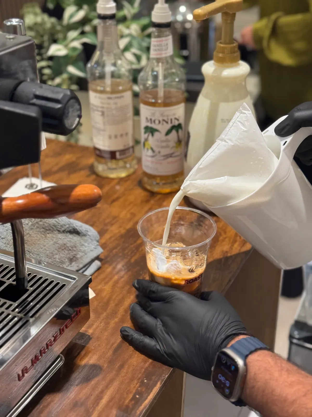 An iced drink being prepared at a wedding coffee cart