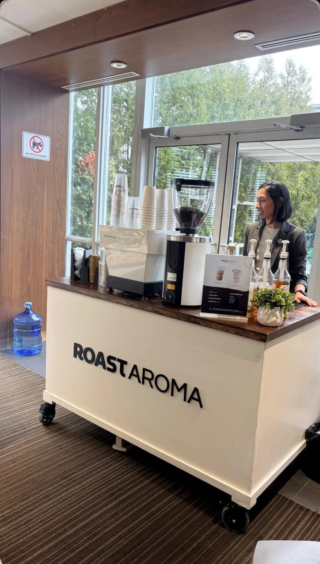 RoastAroma wedding coffee cart positioned beside venue windows